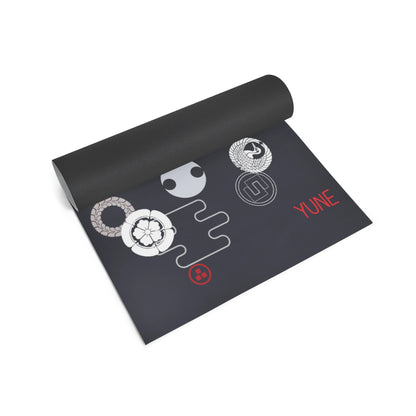 Black yoga mat with white and red designs on a white background