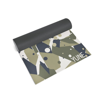 Yoga mat with geometric pattern and 'YUNE' branding on a white background