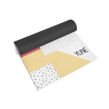 Yoga mat with geometric patterns and 'YUNE' branding on a white background